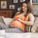 Beautiful Natural Woman In Pregnant Relaxing On Sofa